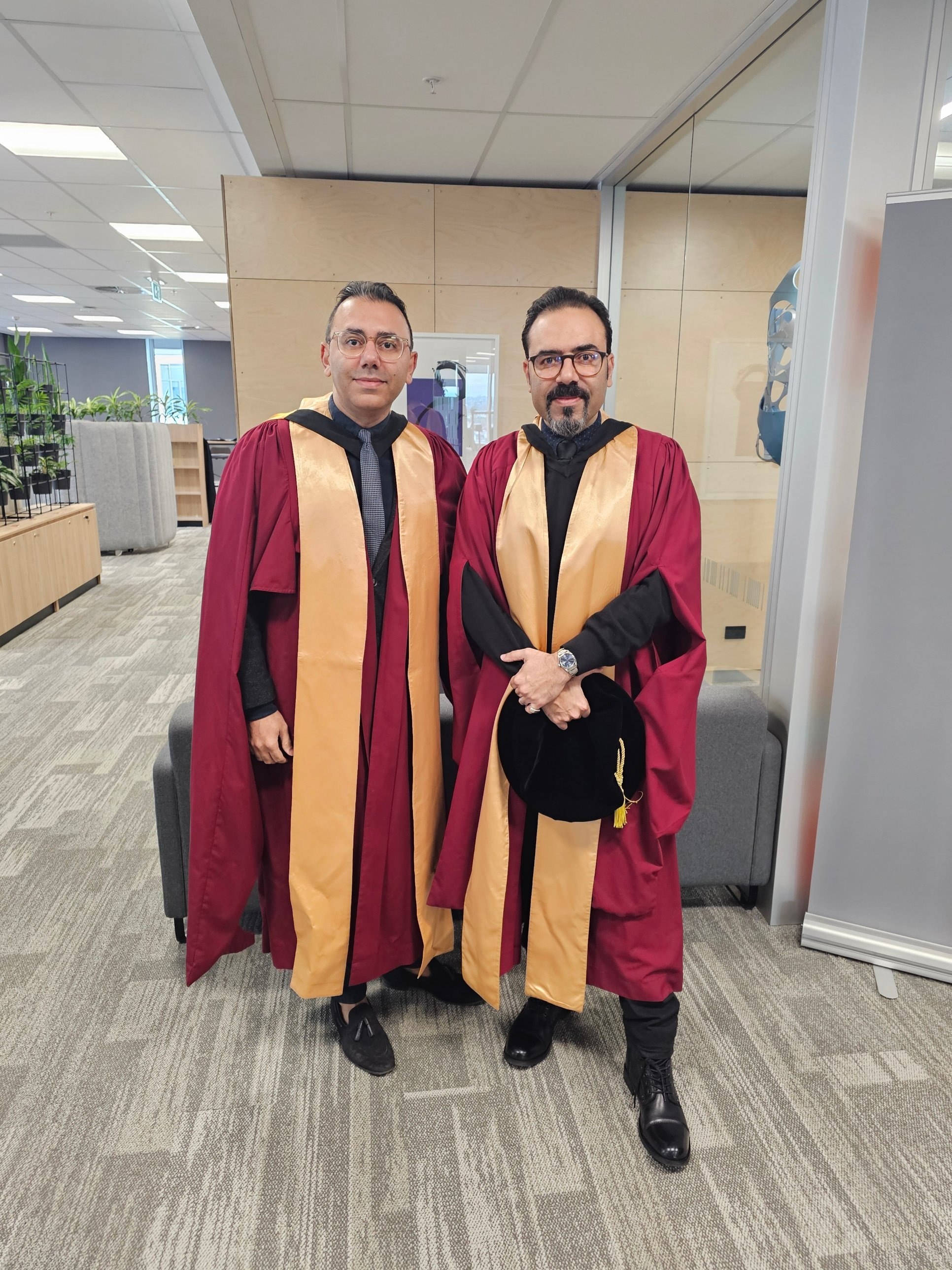 In academic regalia with Professor Ali GhaffarianHoseini at AUT, celebrating graduates.