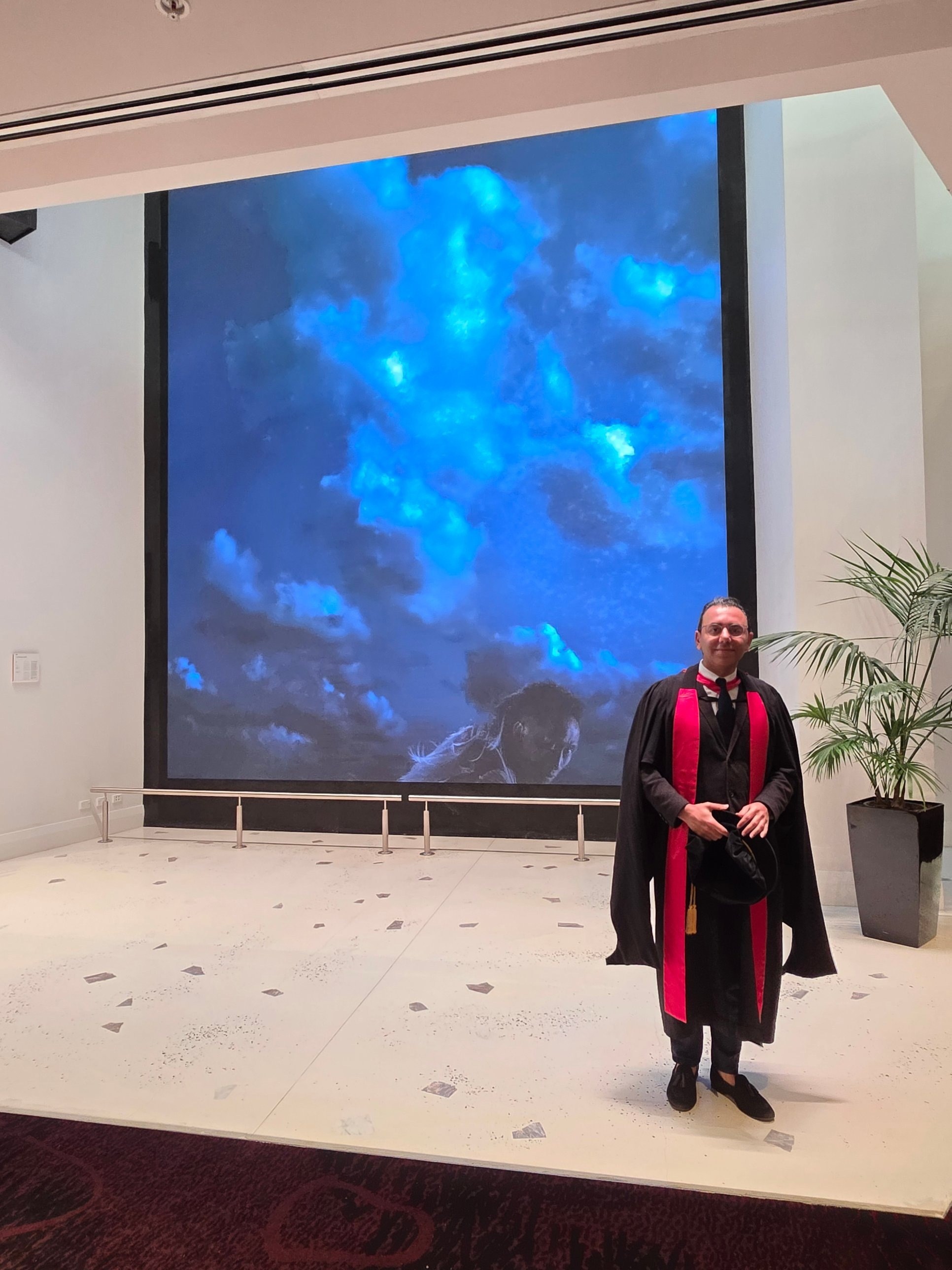 At a graduation ceremony, celebrating the researchers he has supervised.